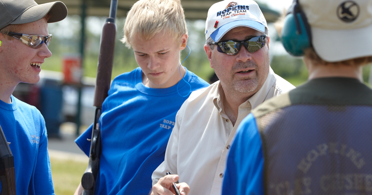 A group of young men are talking to their coach.